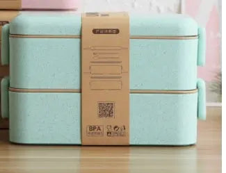 Light green lunch box with a brown lid on a wooden surface